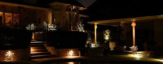 lighting installed around a pool light up the evening