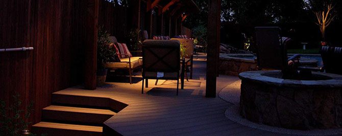 Lights installed around a patio set the poolside mood.