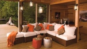 Stylish patio furniture around a well lit outdoor kitchen