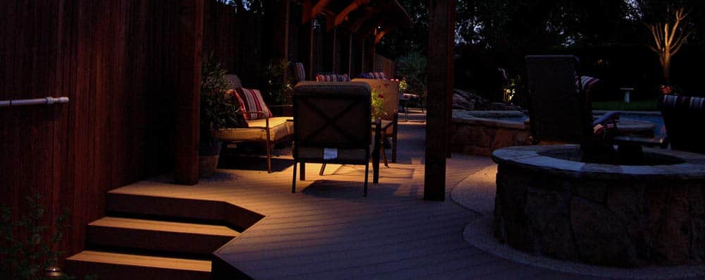 Outdoor lighting sets the mood on the deck around a pool