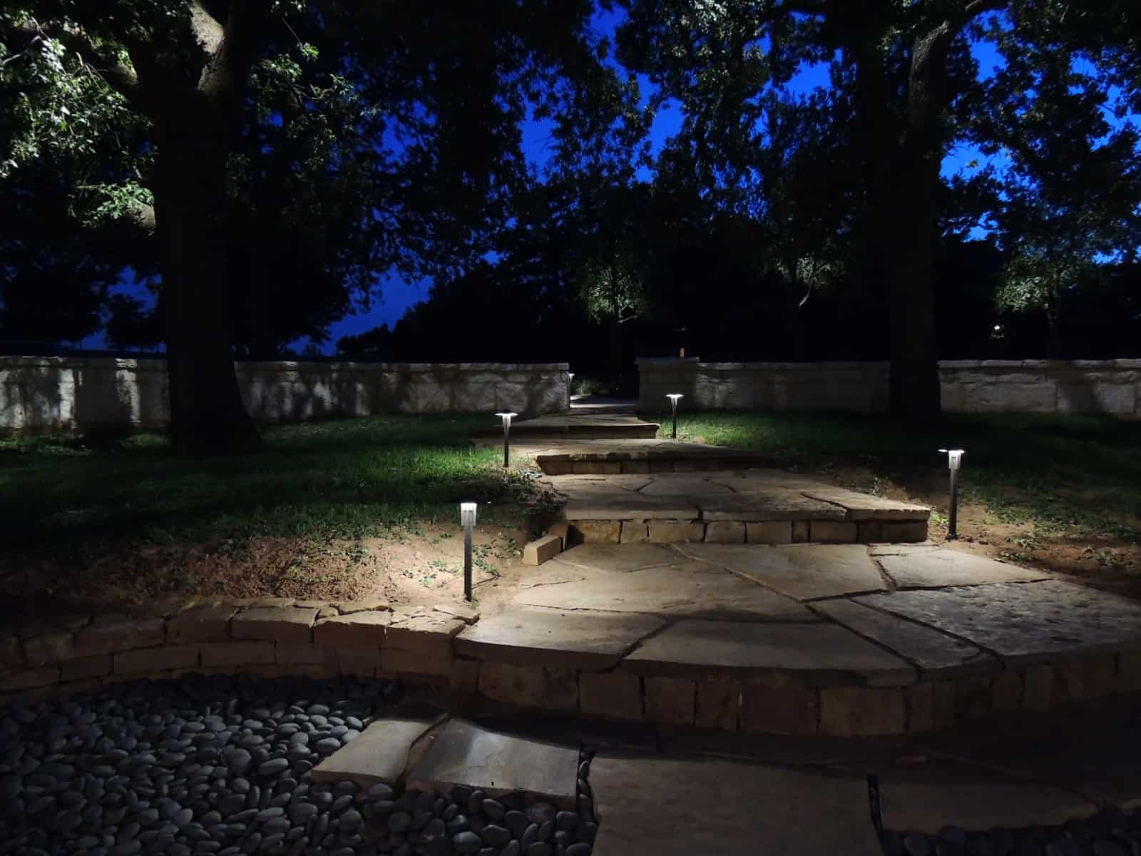 LED Light fixtures line a stone pathway