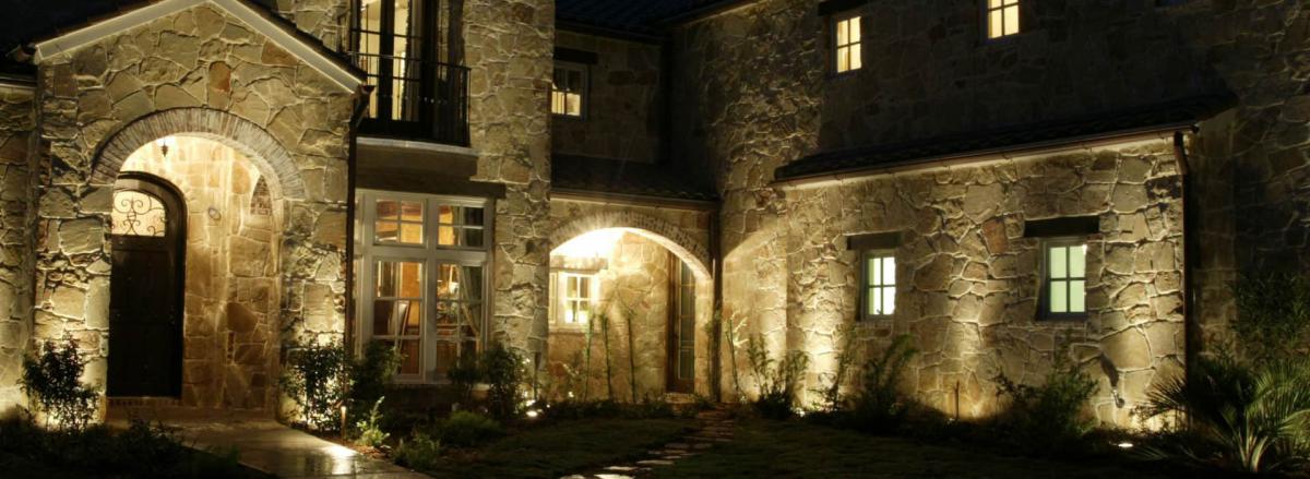 well designed lighting accents the beauty of a stone wall at night