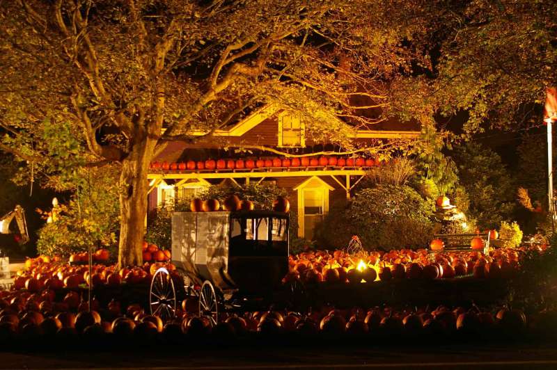 A home decorated for the Harvest season is lit up at night