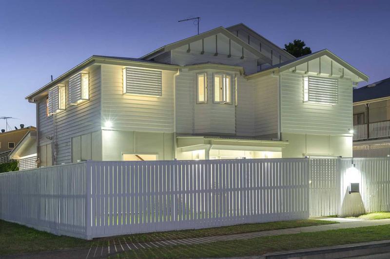 Bright Lights Illuminate a white 2-story home
