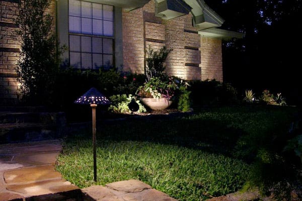 An LED lights the pathway leading to a house