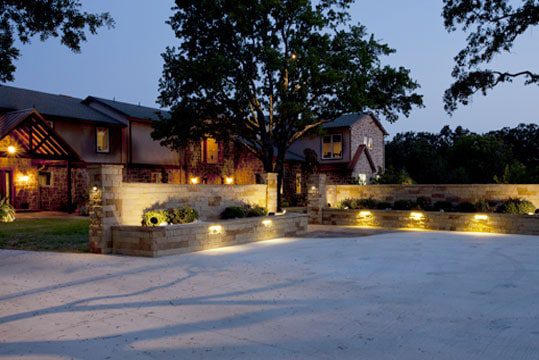 Nice home with well-lit driveway at night