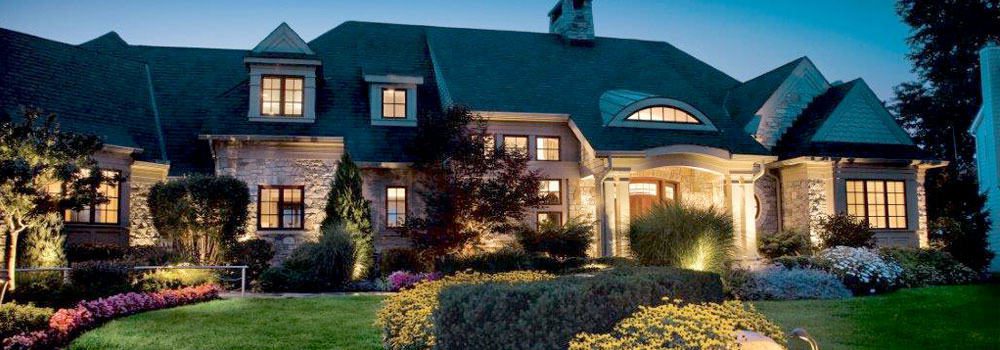 Colorful landscaping and bright lights enhance a home's curb appeal