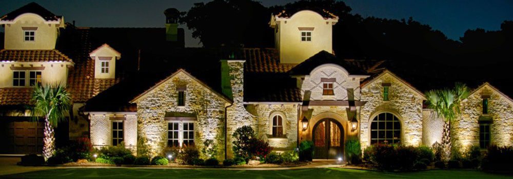 Two story Spanish style home at night