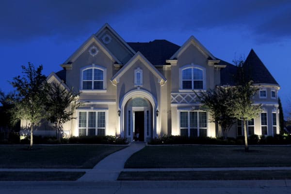 Exterior and landscape lighting accent a Two Story Home in Richardson