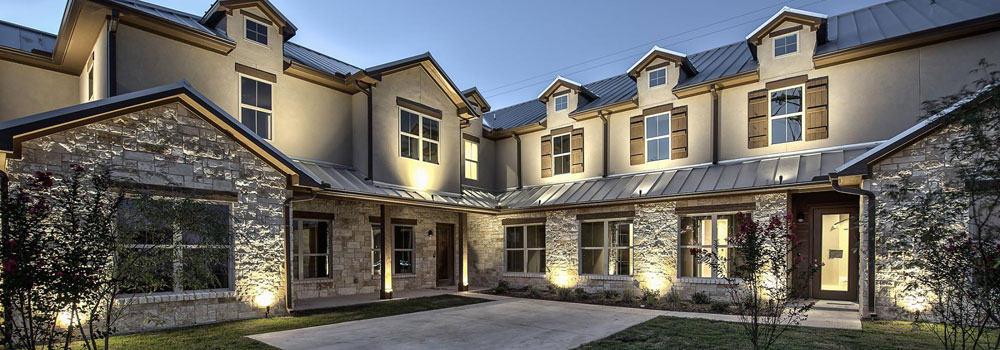 Well-lit exterior of modern rustic office building In Keller