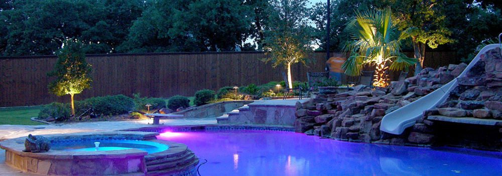 Colorful poolside lighting at dusk beautifies the entire back yard