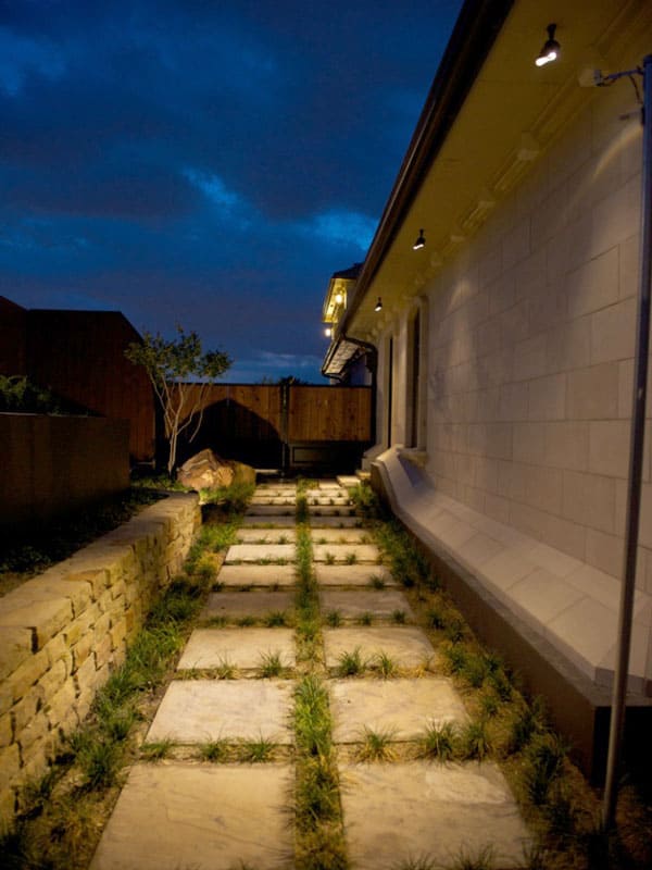 A Backyard pathway is easy to see at night when the lights shine down