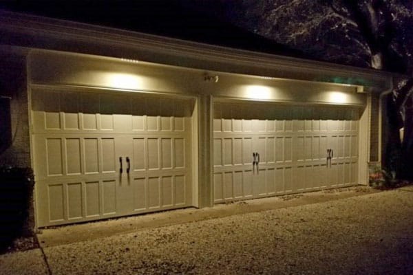 Security Lighting shines on a Three car garage at night