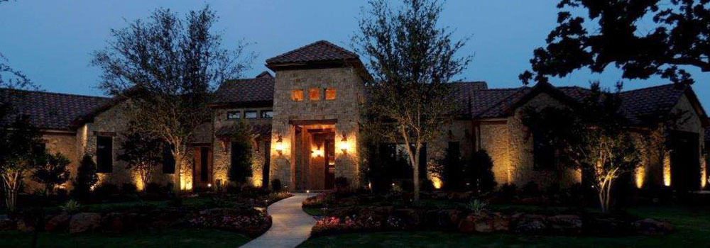 Large single-story home with security lighting