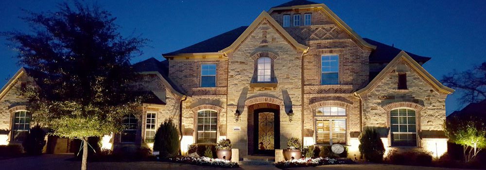 Accented by new LED lighting, a beautiful home is visible at night