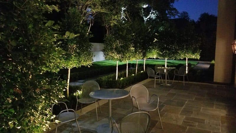 A gorgeous patio with beautiful lights to show off the greenery.